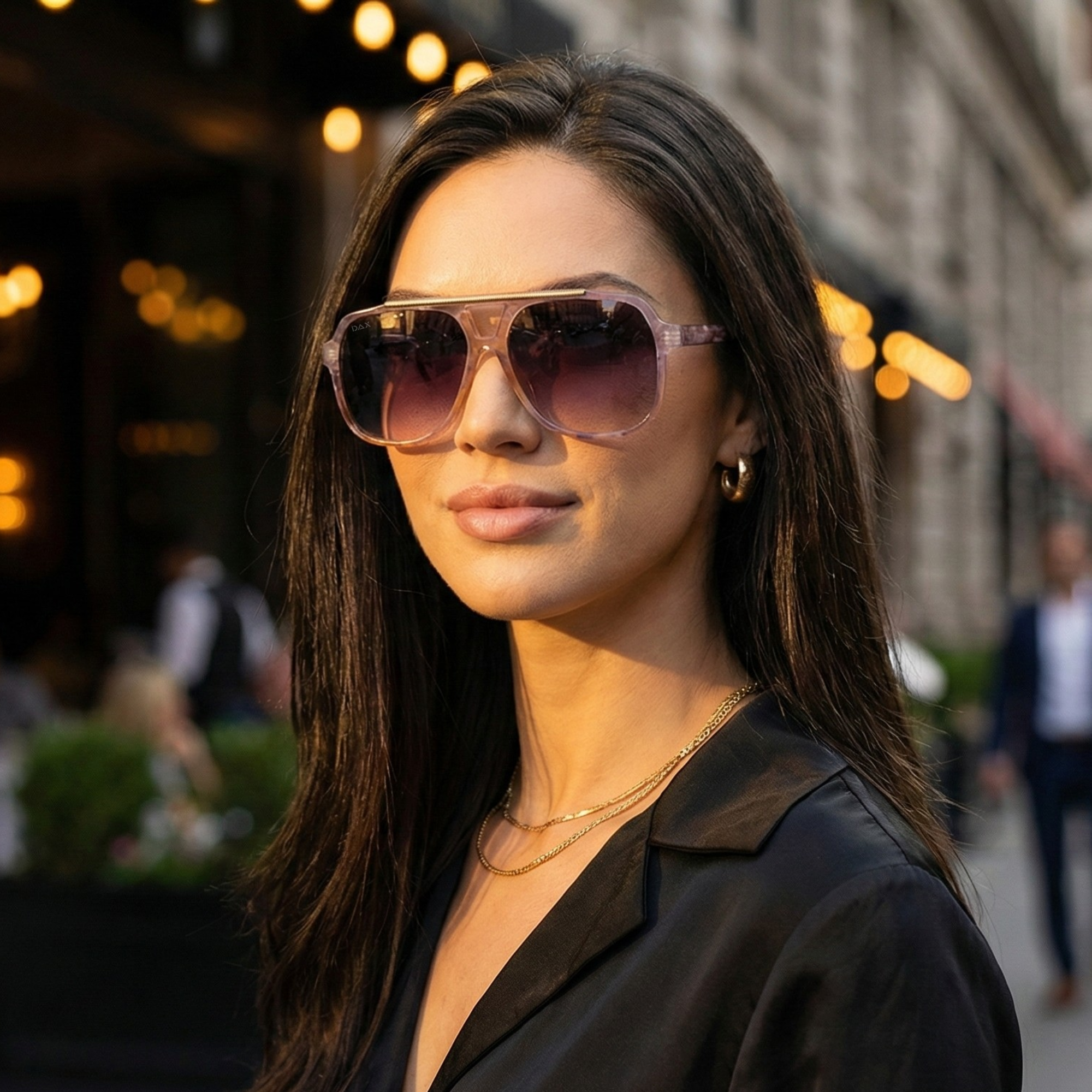 Woman wearing sunglasses with a blurred city street background