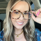 Woman wearing leopard print glasses inside a vehicle