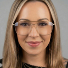 Close-up of a woman wearing glasses with a neutral background