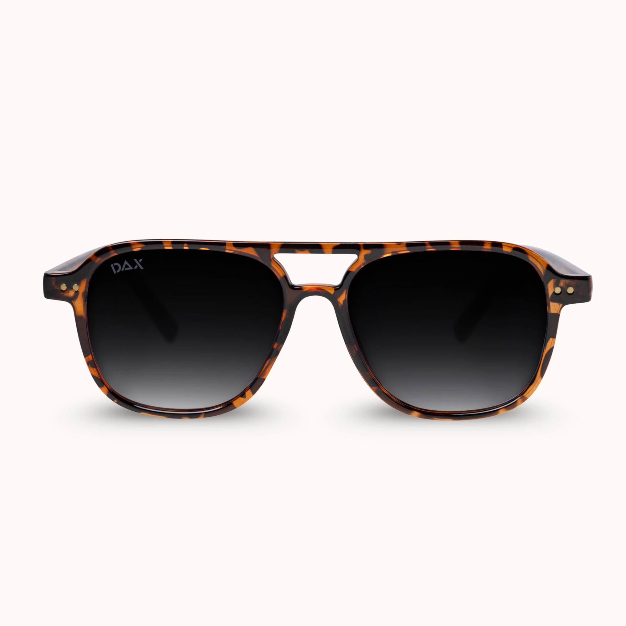 A pair of DAX brand sunglasses with a classic aviator-style frame in a brown and black tortoiseshell pattern, featuring dark gradient lenses, shown against a plain off-white background.