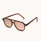 A pair of double-bridge aviator-style sunglasses with a tortoiseshell frame and mirrored pink lenses, shown on a clean off-white background.