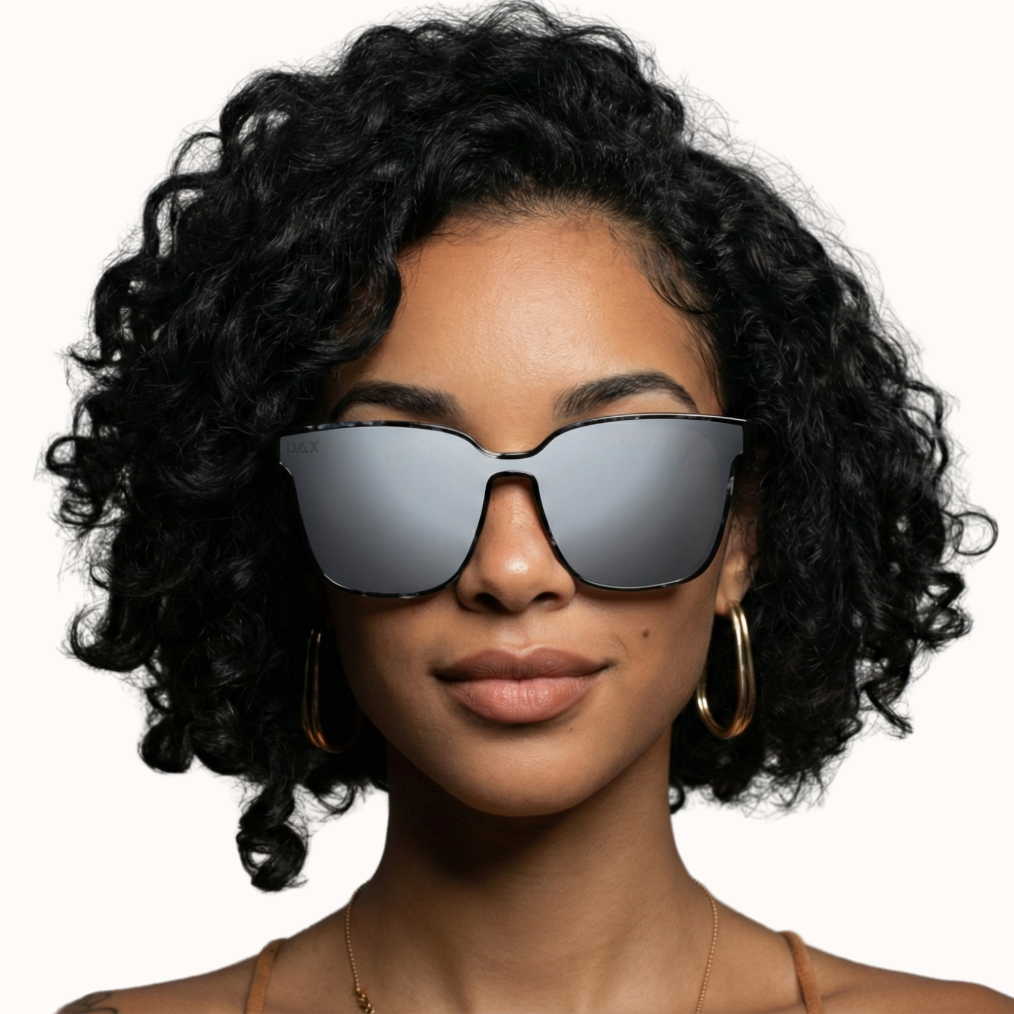Woman wearing reflective sunglasses with a plain background