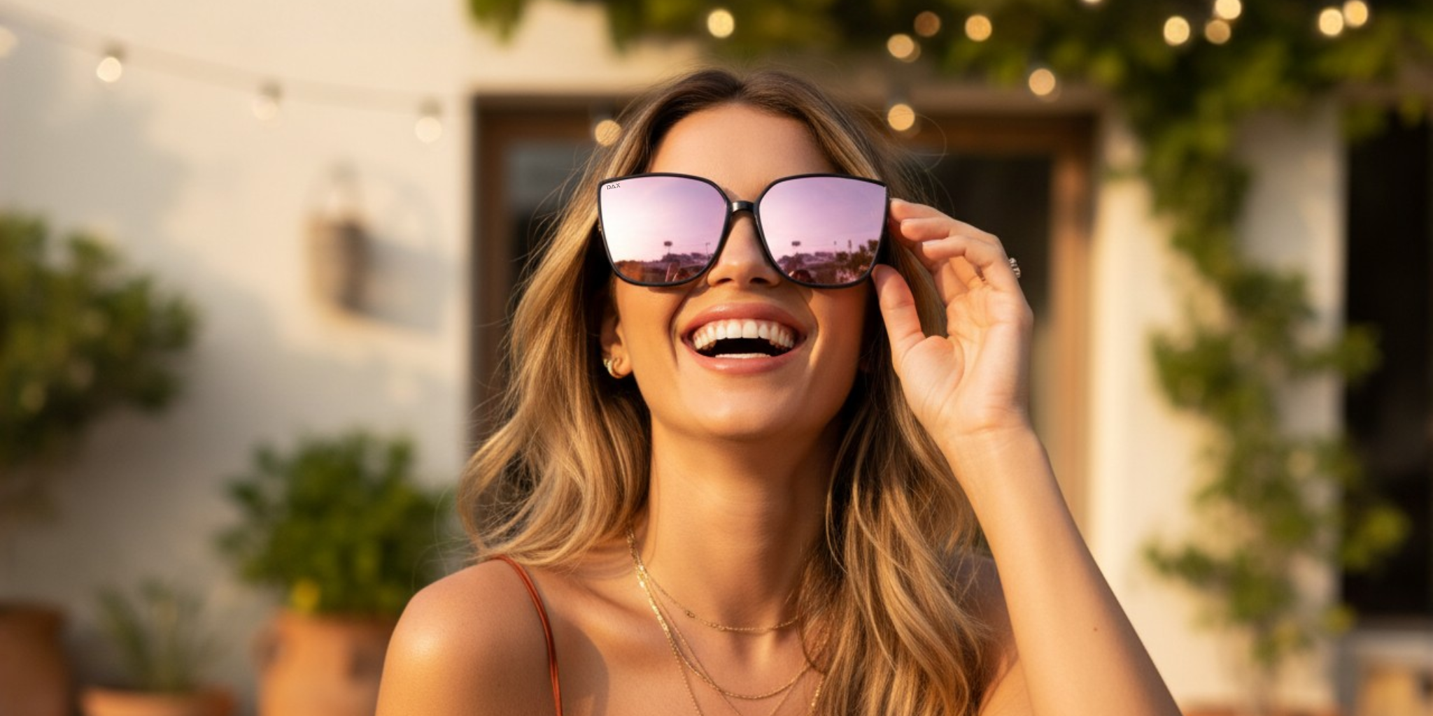 Woman wearing large sunglasses outdoors with a blurred background