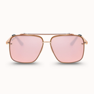 Aviator-style sunglasses with a rose gold metal frame and pink mirrored lenses, shown against a clean off-white background.