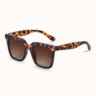 Sunglasses with cheetah frame and brown lenses on a white background