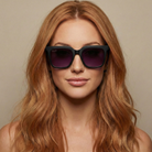 Woman wearing black sunglasses with a neutral background