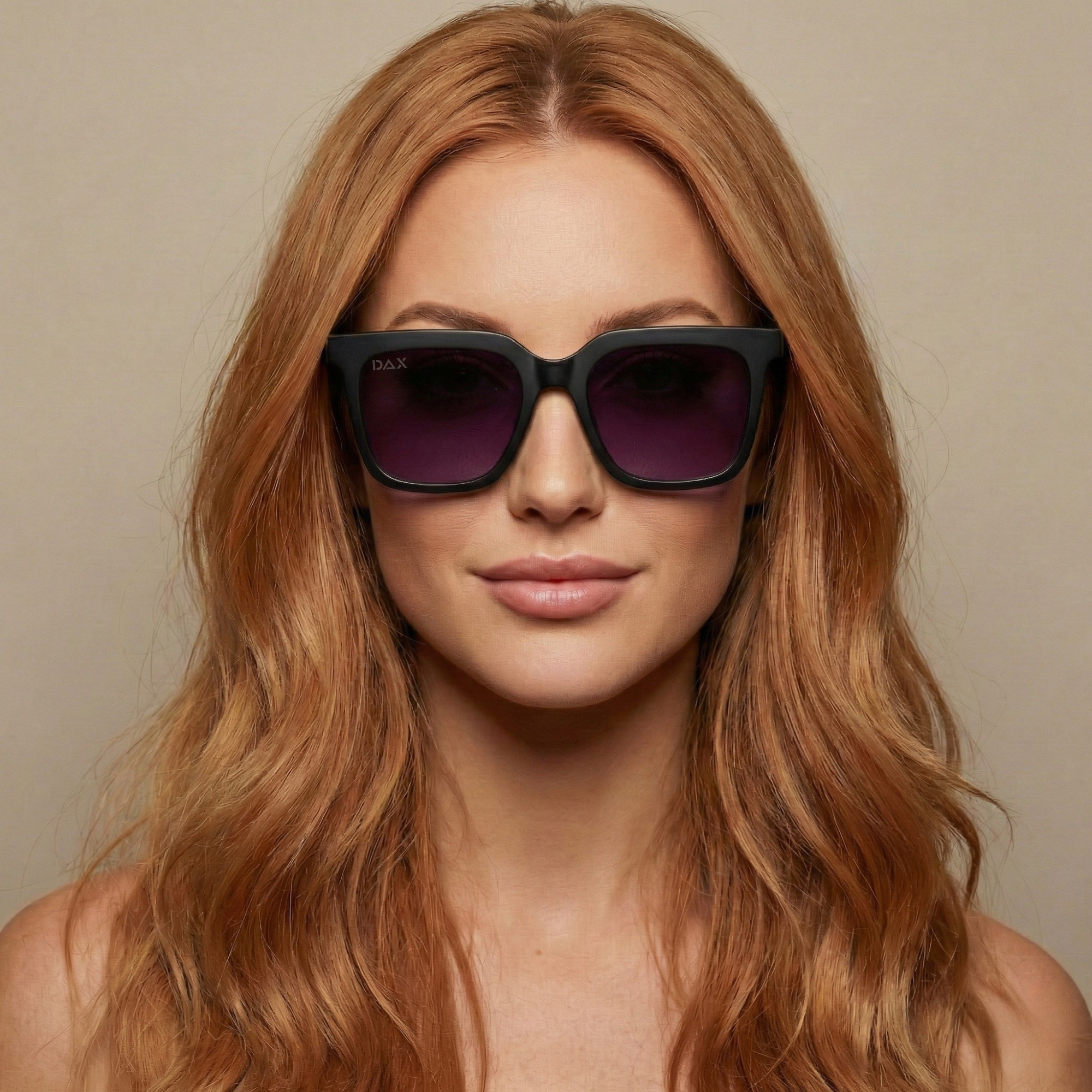 Woman wearing black sunglasses with a neutral background