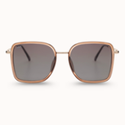 Sunglasses with rose gold frame and dark lenses on a white background
