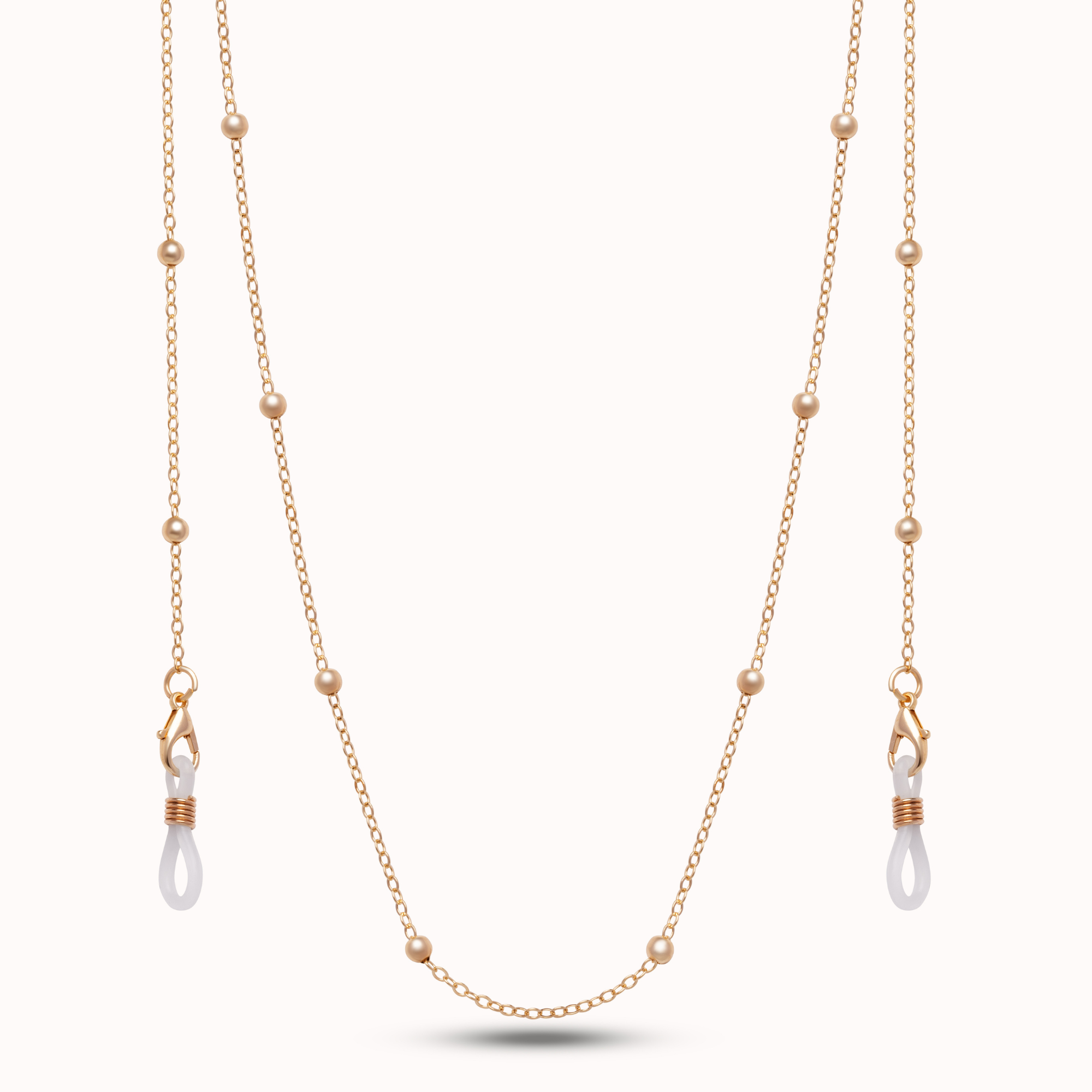 A delicate gold double-strand necklace featuring small bead accents and two drop pendants with white teardrop-shaped beads wrapped in rose gold wire, displayed against a clean white background.