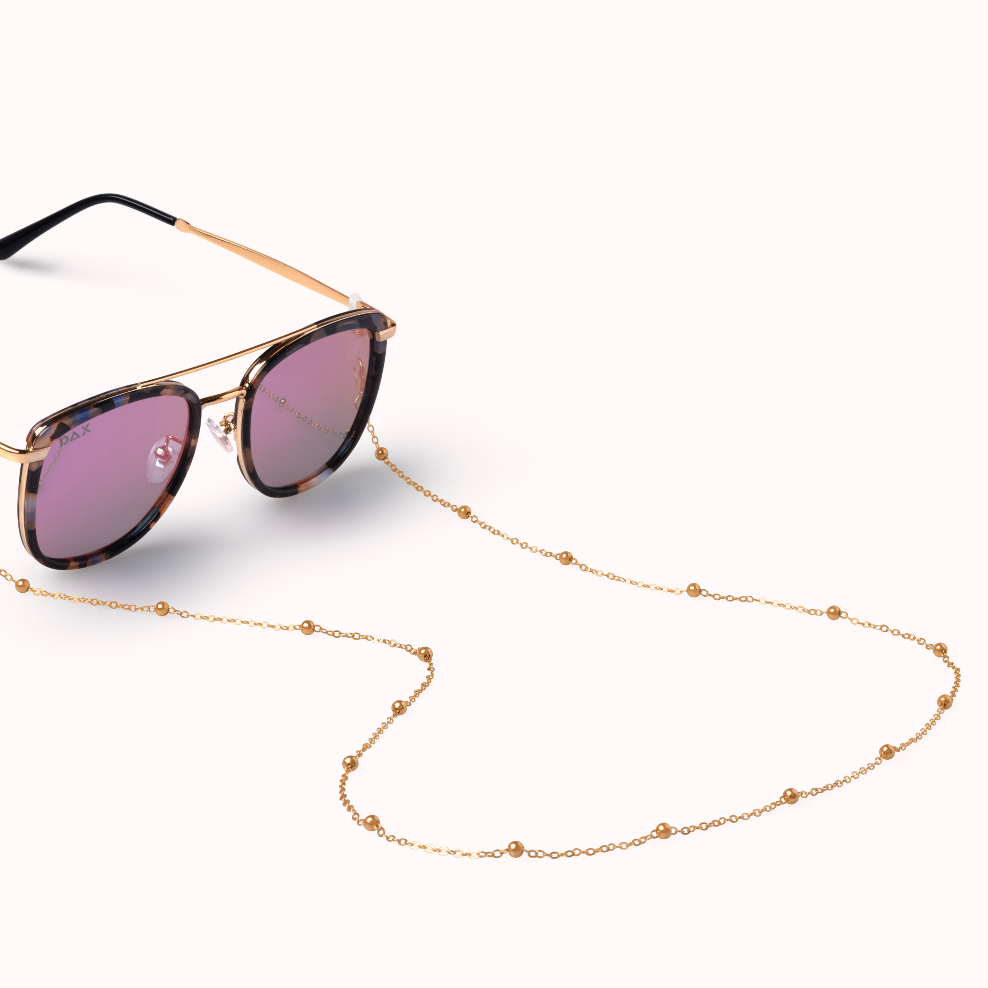 Sunglasses with a gold chain on a white background