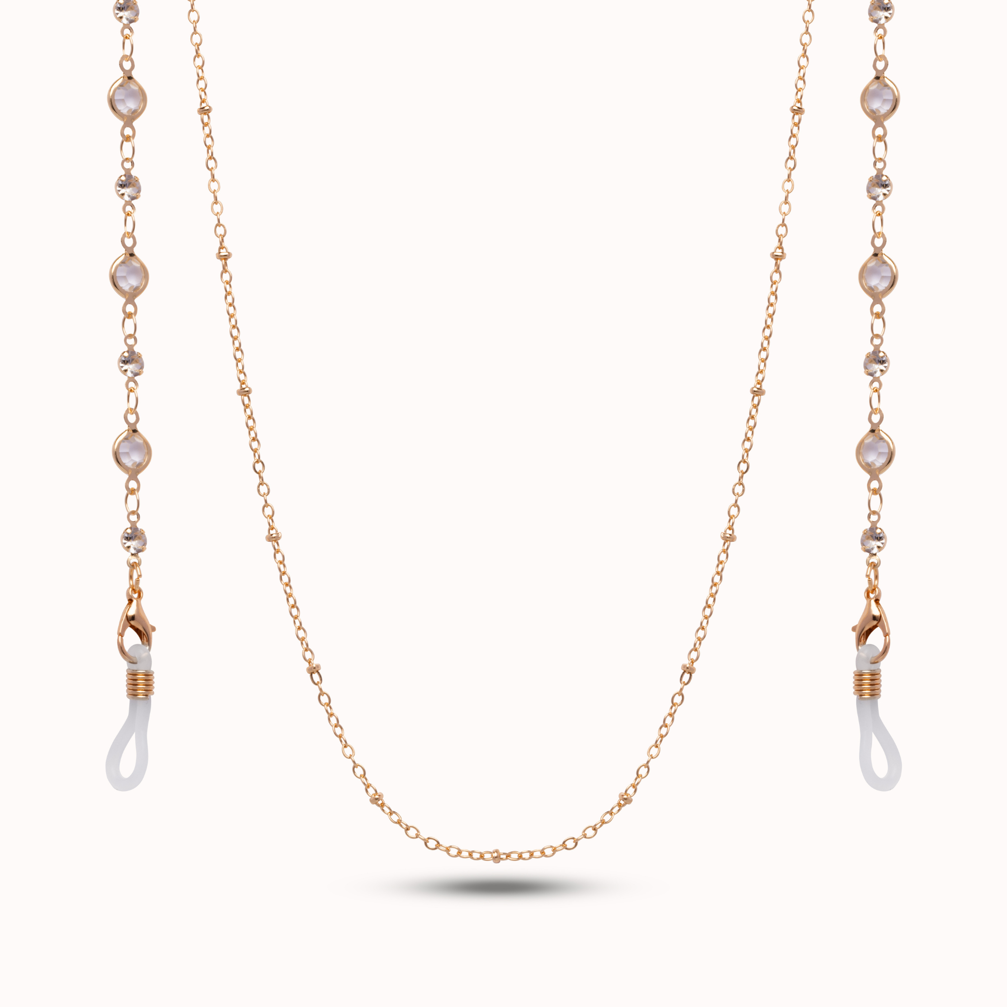 A delicate rose gold chain necklace with pearlescent white bead accents and white silicone ear loops, displayed on a clean off-white background.