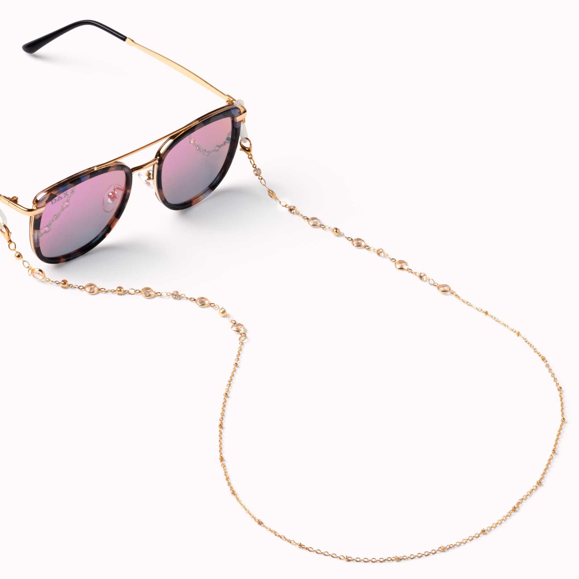 Sunglasses with a gold chain on a white background