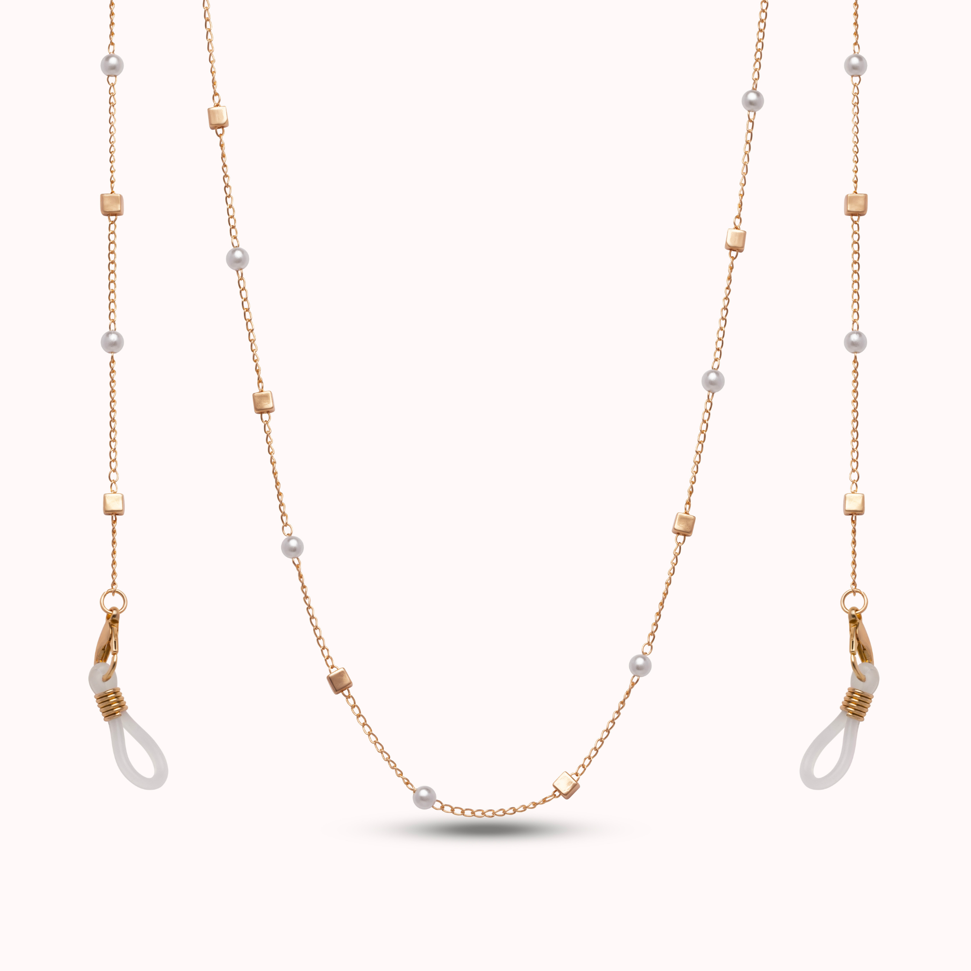 Long chain with gold and rose gold chains and pearl beads on a white background