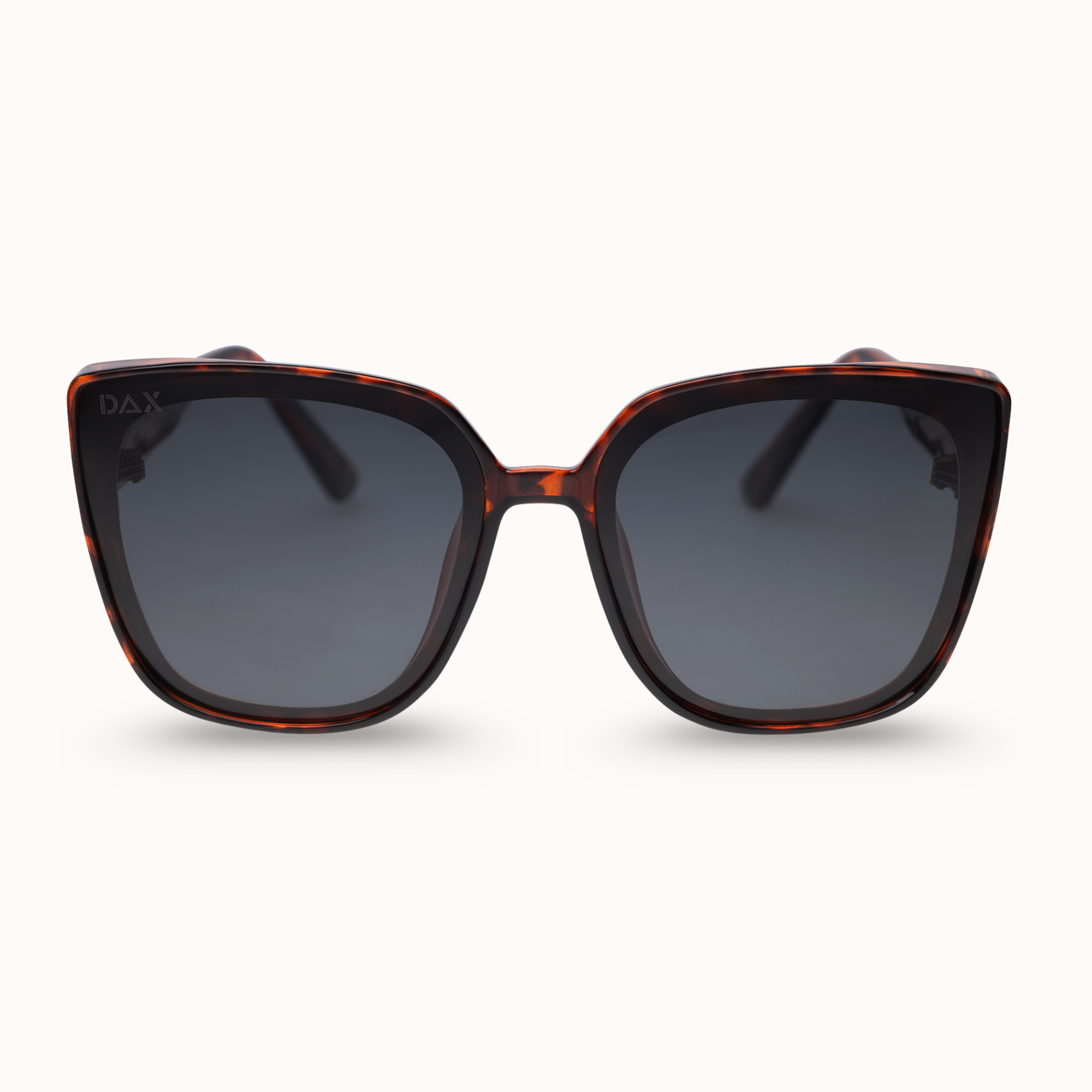 Sunglasses with tortoiseshell frame and dark lenses on a white background