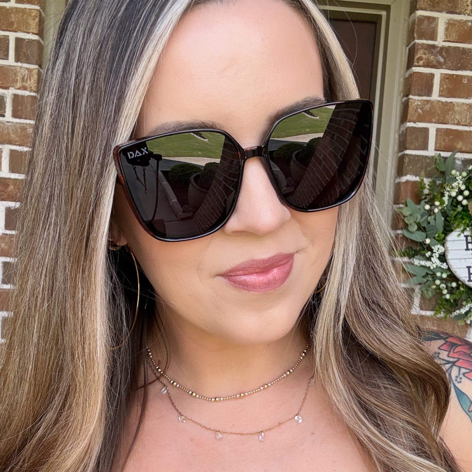 Woman wearing black sunglasses with a blurred background