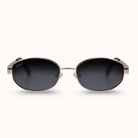 Gold rimmed oval frames with black lenses.
