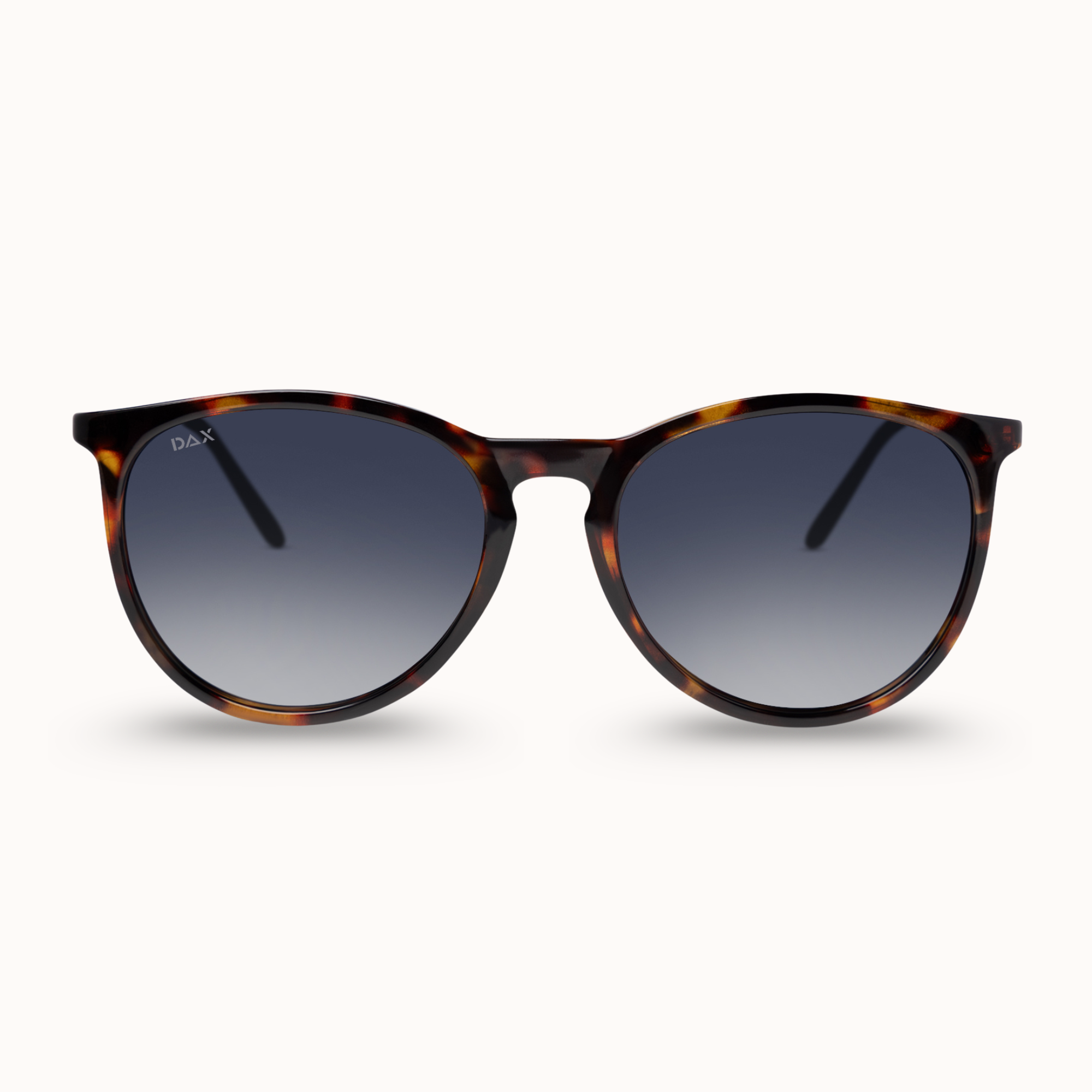 Round sunglasses with a dark brown and black tortoiseshell frame and gradient gray lenses, shown against a light cream background.