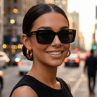 Woman wearing black modern sunglasses on a city street