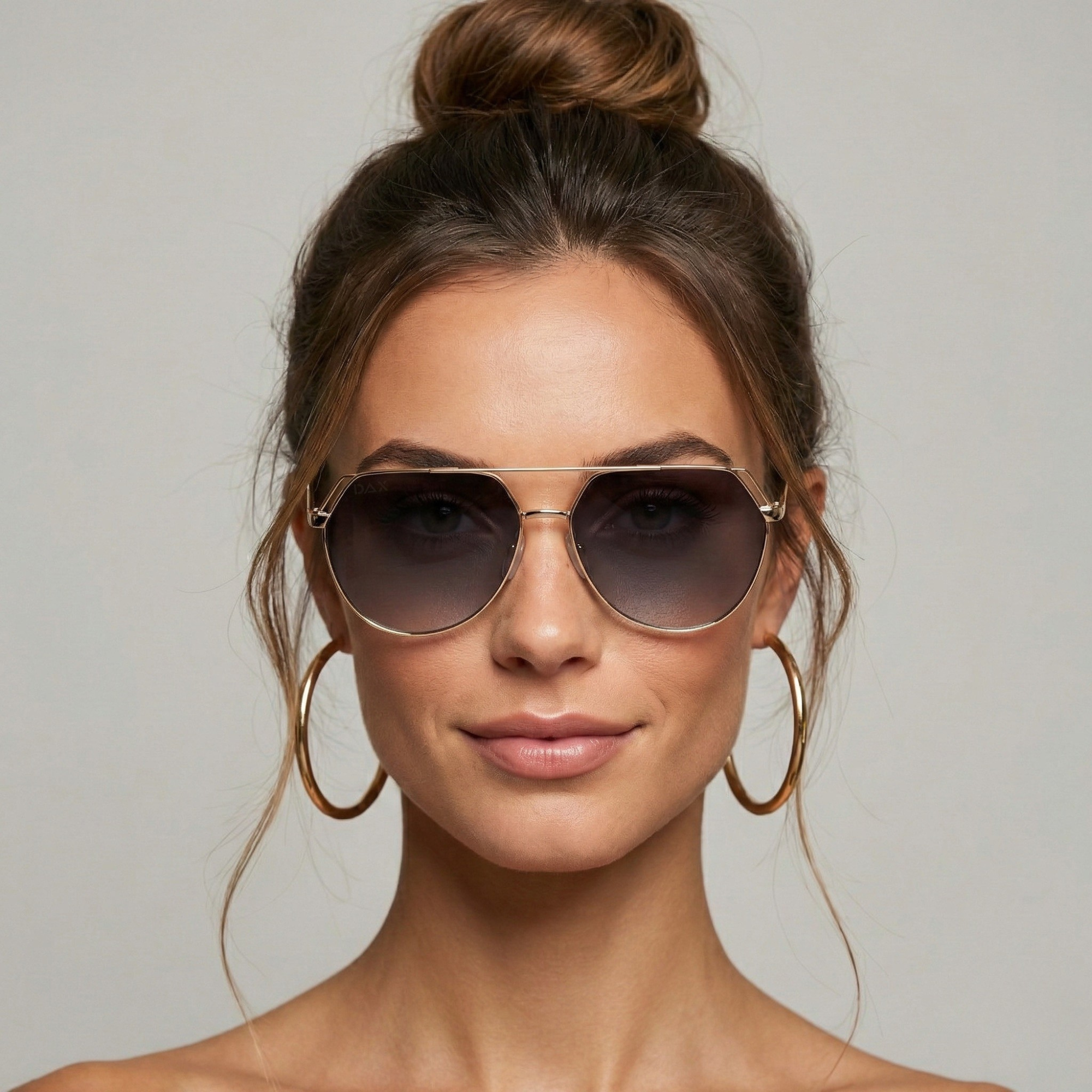 Woman wearing sunglasses with a neutral background