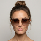 Woman wearing sunglasses with a neutral background