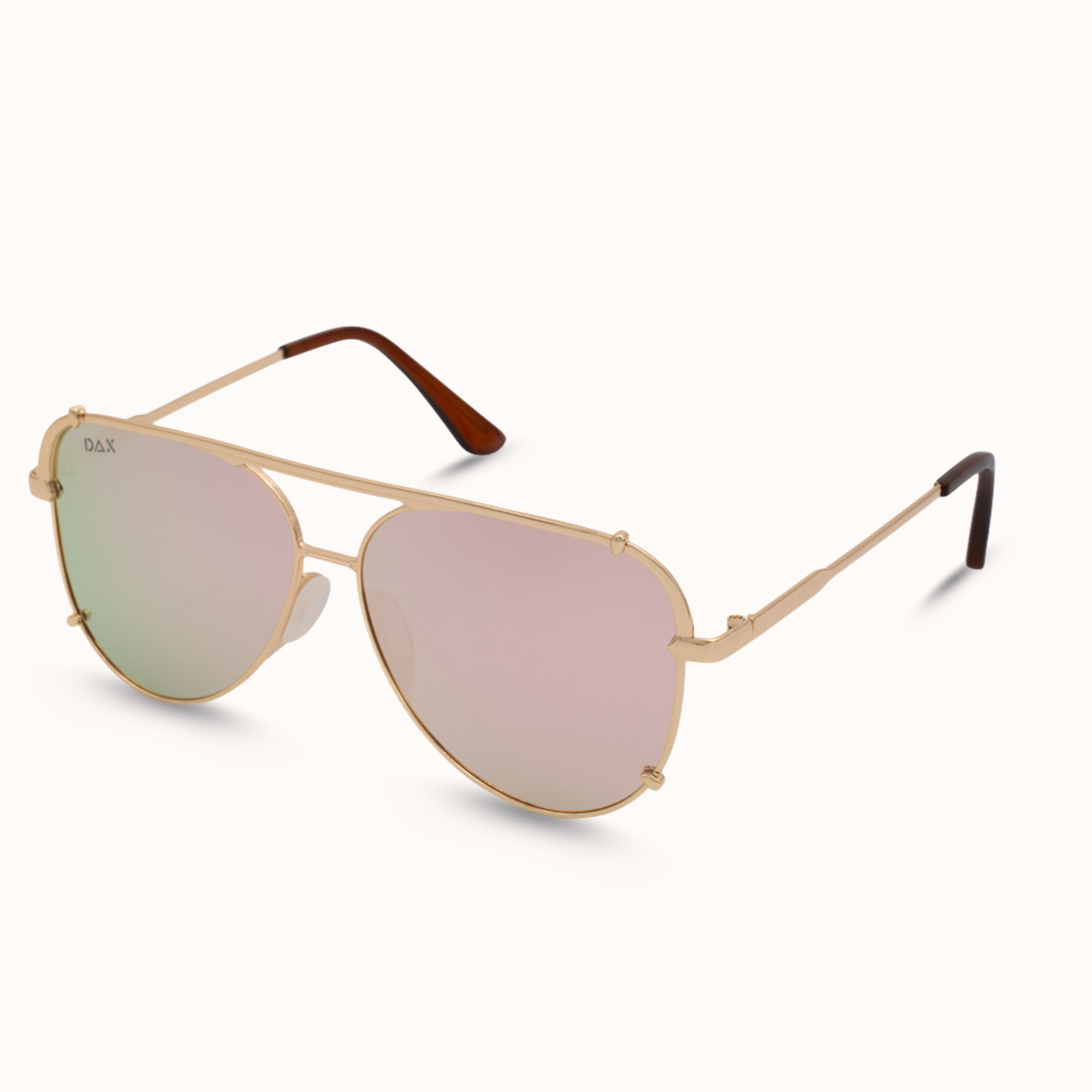 Gold-framed sunglasses with pink-tinted lenses on a white background