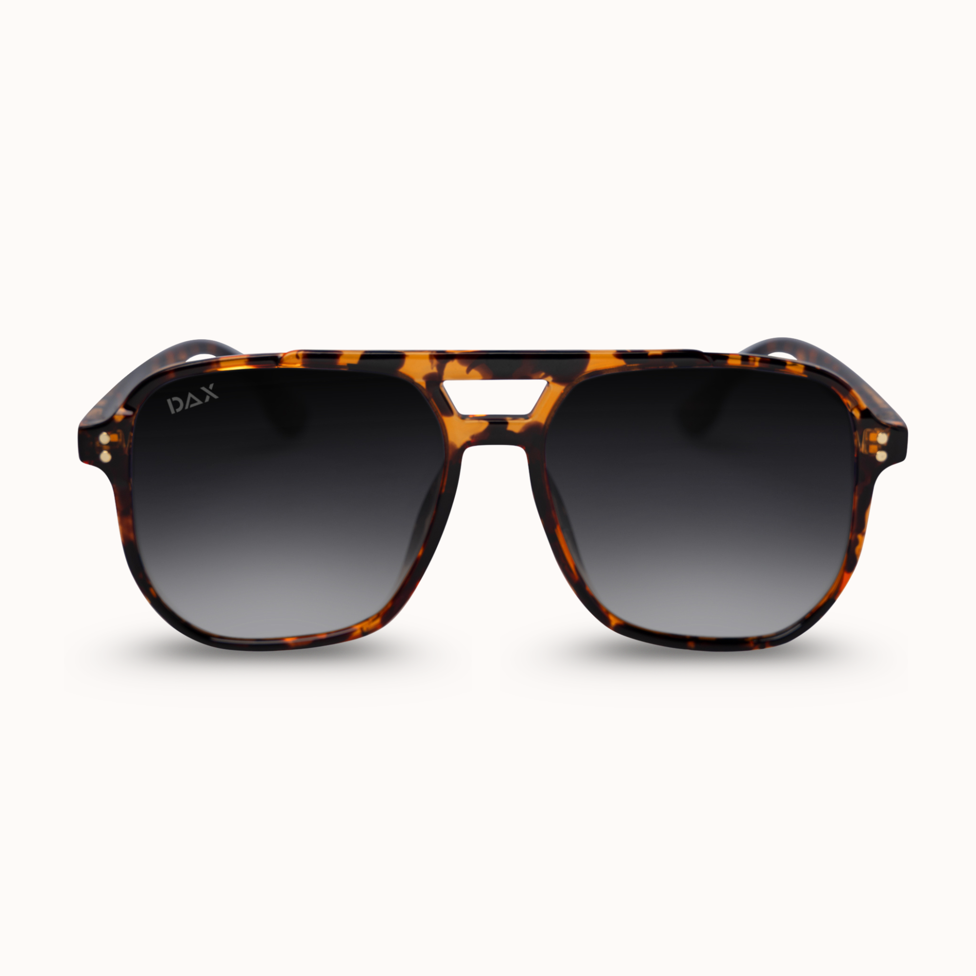 DAX brand aviator-style sunglasses with a brown and black tortoiseshell acetate frame and dark gradient lenses, shown against a clean off-white background.