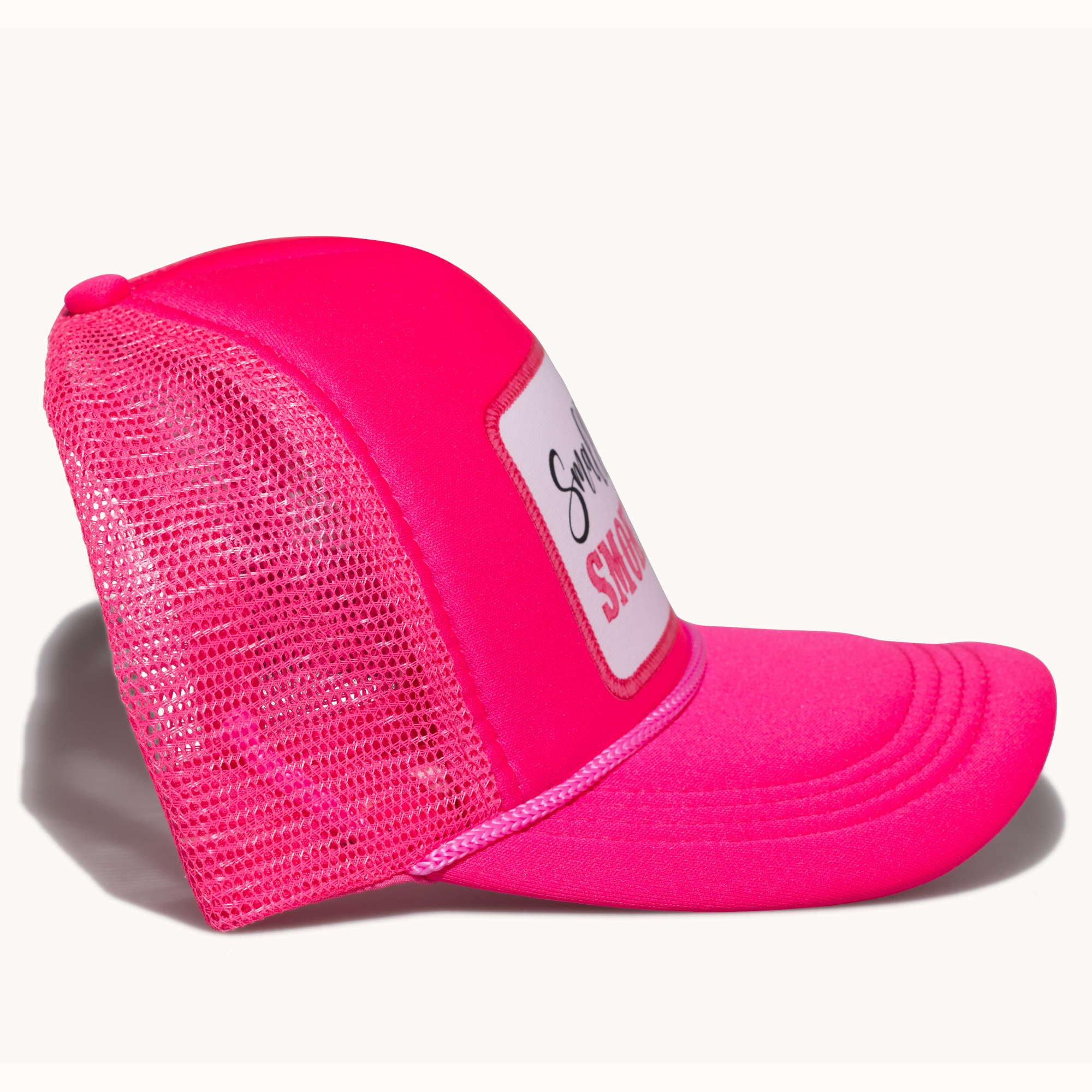 Pink mesh cap with a white patch on a white background