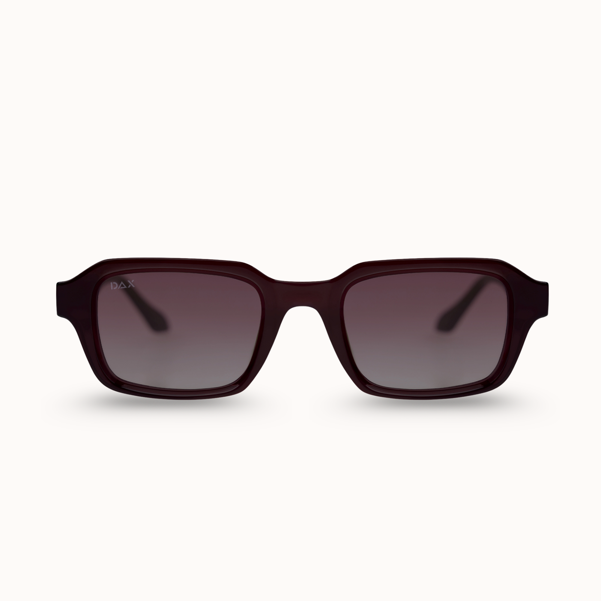 A pair of square sunglasses with a translucent dark burgundy frame and gradient gray lenses, shown against a plain off-white background.
