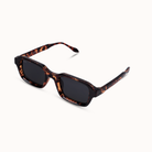 Black sunglasses with a brand logo on a white background